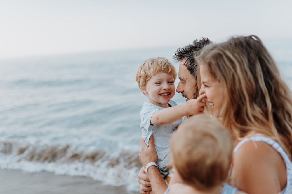 Parents with small children enjoying a day at a beach